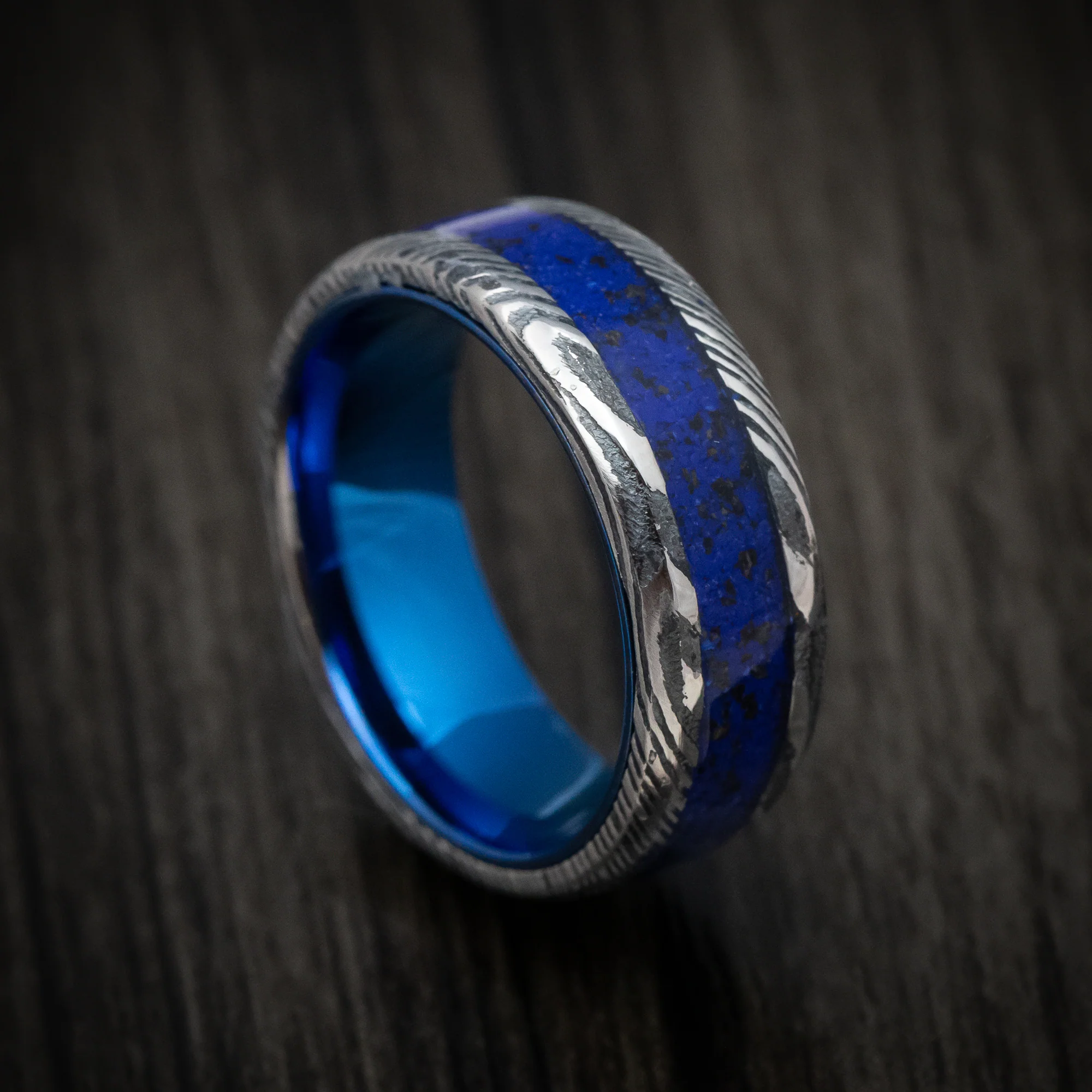 Woodgrain Kuro Damascus Steel with Anodized Sleeve and Custom Dinosaur Bone and Stone Inlay